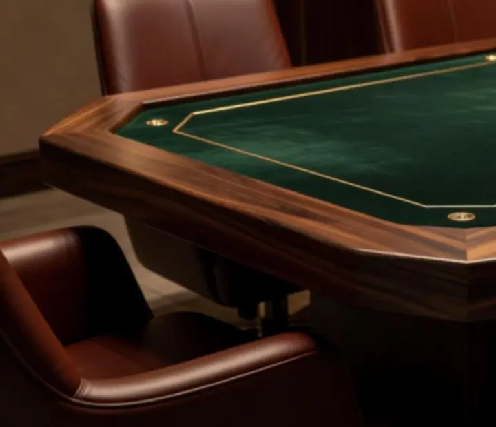 Custom poker tables with emerald felt and chip stacks in a dark luxe card room